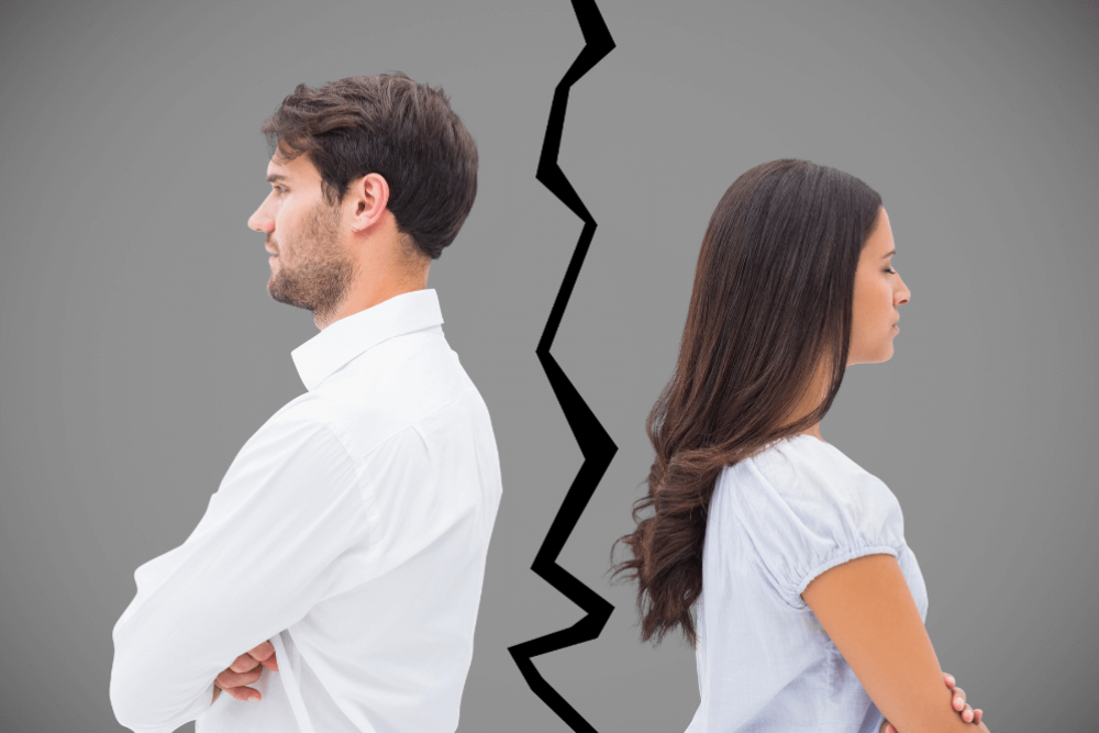 A man and a woman stand back-to-back with arms crossed, separated by a jagged line on a gray background, suggesting a division or conflict between them.