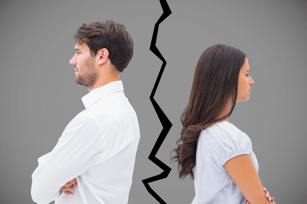 A man and a woman stand back-to-back with arms crossed, separated by a jagged line on a gray background, suggesting a division or conflict between them.